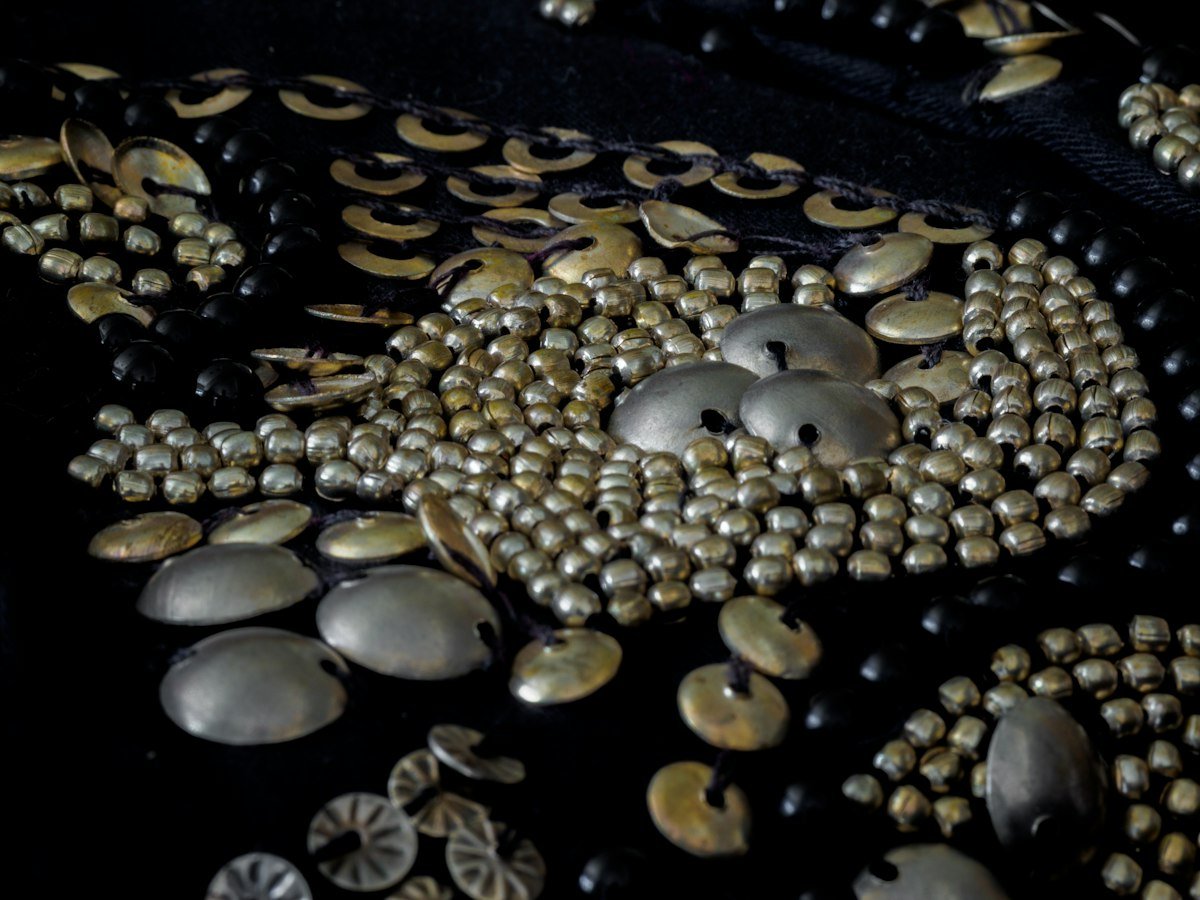 Close-up of intricate beadwork on a bride’s gele and necklace