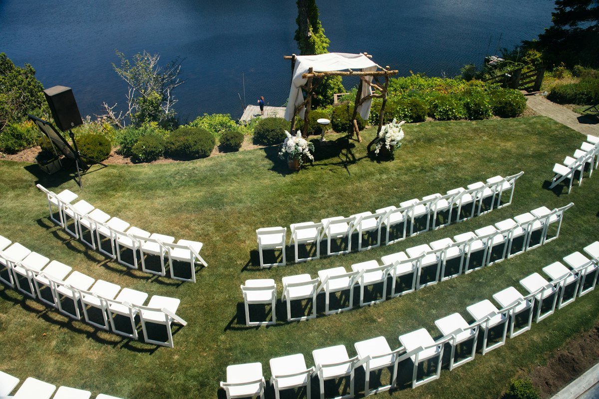 A serene outdoor wedding setup with lush greenery and elegant decor.